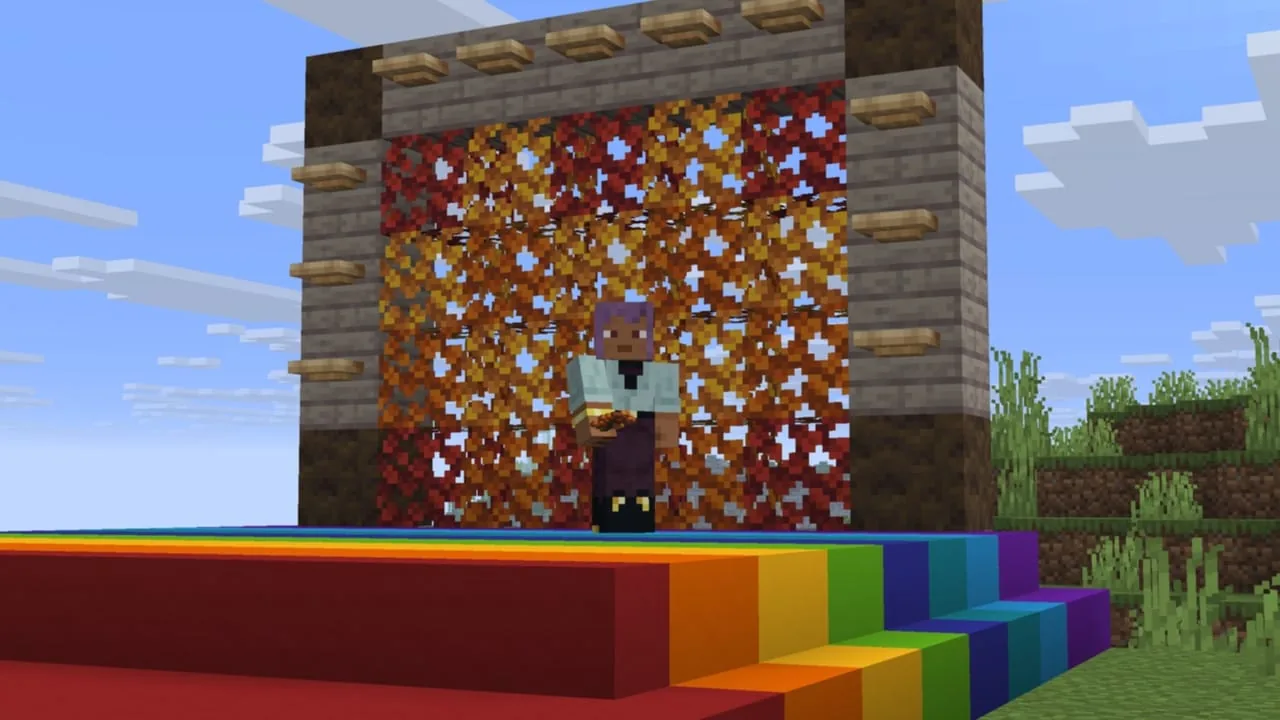 Ein Spieler auf einer Treppe aus regenbogenfarbenem Beton vor einer Wand aus roten, orangen und gelben Blättern