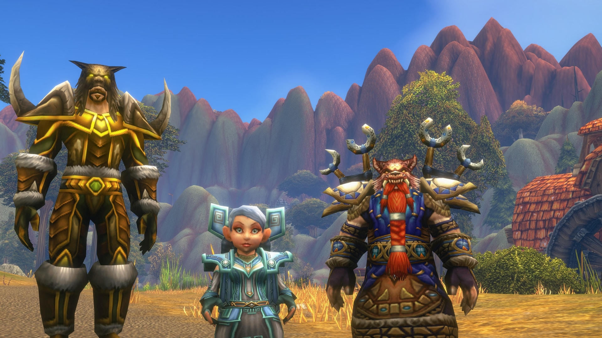 Un tauren, una gnoma e un nano in armatura su una strada sterrata sotto montagne rosse: la copertina dell'articolo di Blizzard sulla prenotazione dei nomi di WoW Forever